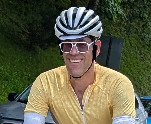 Scott Weinstein in a helmet and yellow jersey, on a ride